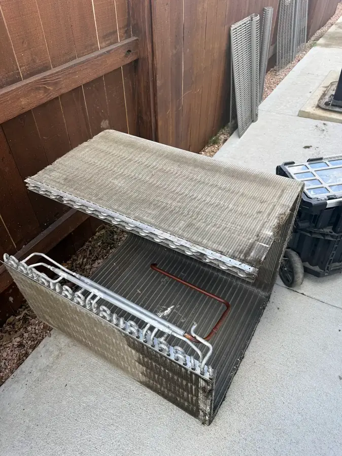 Disassembled condenser coils staged for repair