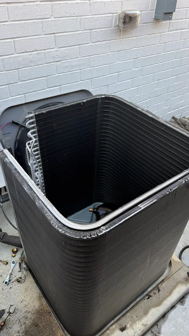 Residential condenser installed against a brick exterior wall by Prime Texas Air